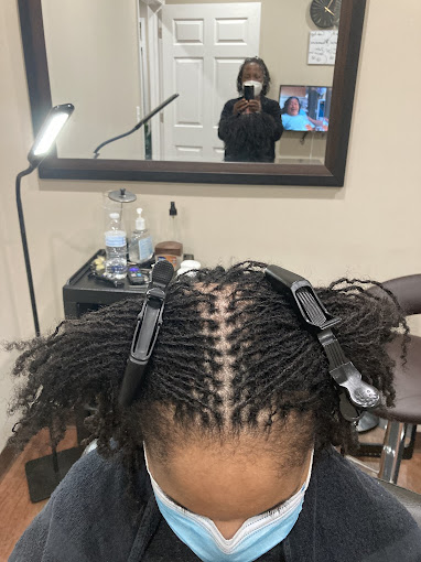 A person with a camera in a room with a mirror