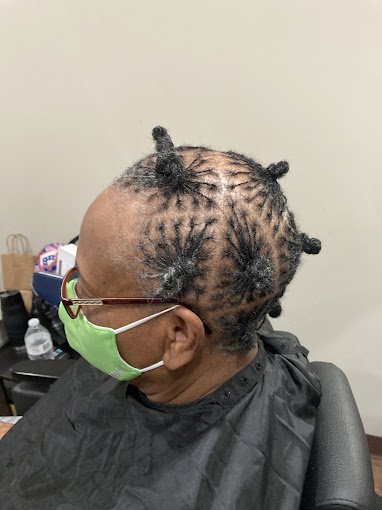 A person with a mask on sitting in a chair