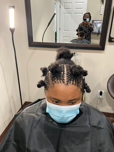 A woman getting her hair done in a salon