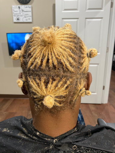 A person with dreadlocks sitting in a chair